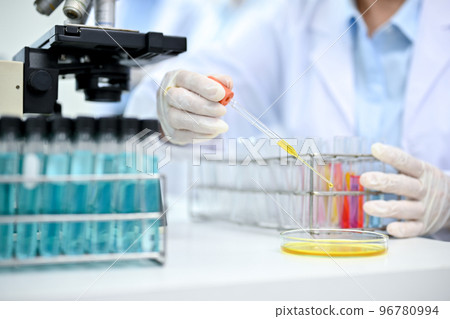 Close-up, Professional chemist or scientist adjust liquid chemical samples in test tubes 96780994