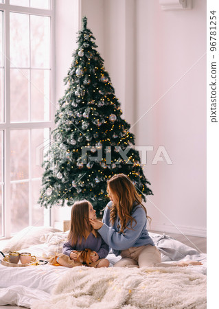 Young mother and daughter 5-6 years old in knitted blue sweaters 96781254