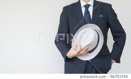 A man in a suit with a fedora 96781540