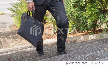 Businessman climbing stairs 96782123