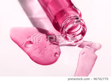 Fluid hyaluronic acid, serum, cosmetic gel flowing out of the bottle on white background. Beauty, science and healthcare concept. Dose of retinol in macro. Beauty product presentation 96782770