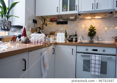Food delivery service containers on table white scandi festive kitchen in christmas decor. Eve New year, saving time, too lazy to cook, hot order, disposable plastic box in fairy light. mock up Food delivery service containers on table white scandi festive kitchen in christmas decor. Eve New year, saving time, too lazy to cook, hot order, disposable plastic box in fairy light. mock up 96782887