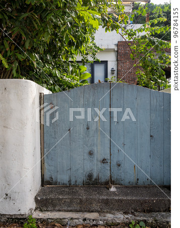 Wooden gate and fence on the front of the home garden. Wooden gate and fence on the front of the home garden. 96784155