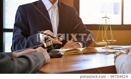 A professional male lawyer is giving advice and consulting on the lawsuit with his client A professional male lawyer is giving advice and consulting on the lawsuit with his client 96784624
