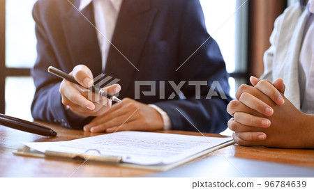 A male real estate agent or business consultant is meeting, talking, and giving advice to his client 96784639