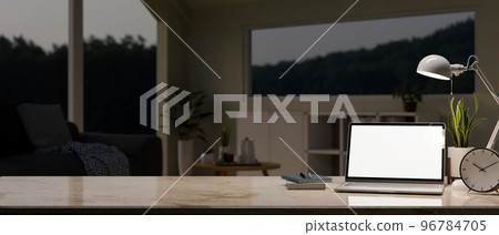 Workspace with laptop mockup and copy space on marble tabletop over blurred living room 96784705