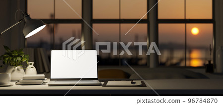 Workspace in modern office in the evening with laptop mockup and sunset view on the window 96784870