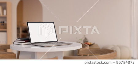 Minimal working space with laptop mockup on the white round table over blurred minimal living room Minimal working space with laptop mockup on the white round table over blurred minimal living room 96784872