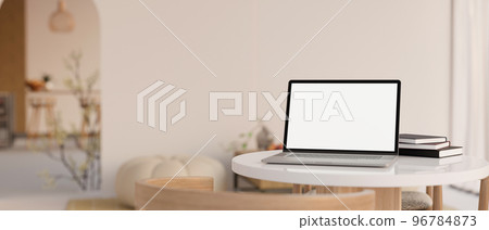 Notebook laptop white screen mockup is on a white table in cozy minimal cafe coffee shop. 96784873