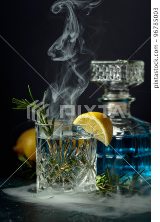 Smoked rosemary old-fashioned cocktail. Smoked rosemary old-fashioned cocktail. 96785003