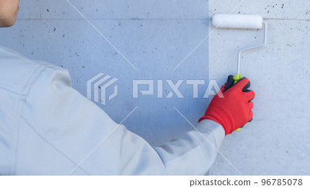 Image of exterior wall painting | worker with concrete wall and paint roller Image of exterior wall painting | worker with concrete wall and paint roller 96785078