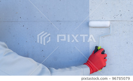 Image of exterior wall painting | worker with concrete wall and paint roller Image of exterior wall painting | worker with concrete wall and paint roller 96785079