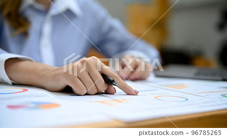 close-up hand, A businesswoman finger pointing on her financial report. close-up hand, A businesswoman finger pointing on her financial report. 96785265