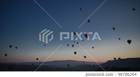 Sunrise panoramic view to Goreme city and flying balloons, Cappadocia, Turkey Sunrise panoramic view to Goreme city and flying balloons, Cappadocia, Turkey 96786264