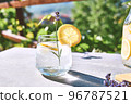 Cool lavender homemade lemonade with lemon slices and lavender flower. Healthy organic summer soda drink. Detox water. Diet unalcolic coctail. 96787521