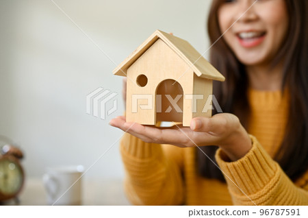 close-up image, A beautiful Asian female putting a house model on her hands. Real estate agent close-up image, A beautiful Asian female putting a house model on her hands. Real estate agent 96787591