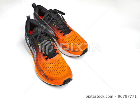 Orange sneakers on isolated on white background with copy space. Healthy active lifestyle shoes Orange sneakers on isolated on white background with copy space. Healthy active lifestyle shoes 96787771