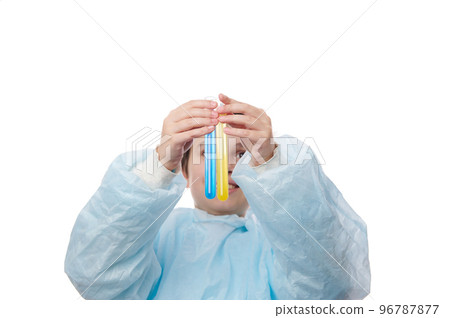 Upbeat teenage boy in blue lab coat, lifting up test tubes with chemical liquid and showing the ongoing reaction inside it to the camera, while having a chemistry class in scientific school laboratory Upbeat teenage boy in blue lab coat, lifting up test tubes with chemical liquid and showing the ongoing reaction inside it to the camera, while having a chemistry class in scientific school laboratory 96787877