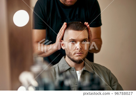 Barber and satisfied bearded man in front of the mirror 96788027