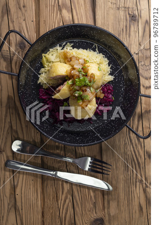 dumpllings filled with smoked meat served with red and white cabbage dumpllings filled with smoked meat served with red and white cabbage 96789712