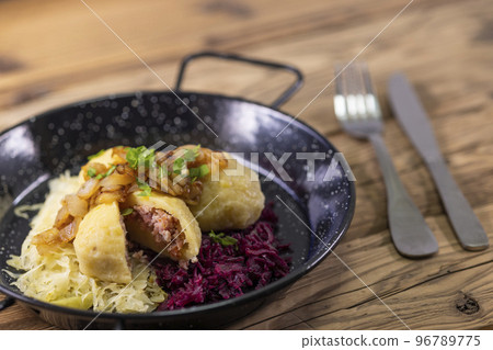 dumpllings filled with smoked meat served with red and white cabbage dumpllings filled with smoked meat served with red and white cabbage 96789775