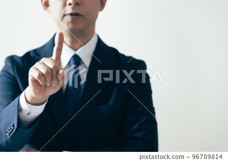 Businessman raising index finger Businessman raising index finger 96789814
