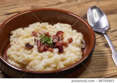 Slovakian halusky served with sheep cheese and roasted bacon 96789863