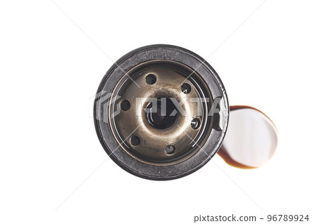 Car oil filter with a puddle of engine oil isolated on white background Car oil filter with a puddle of engine oil isolated on white background 96789924