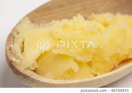 Ghee in wooden spoon isolated on white background,top view. 96789955