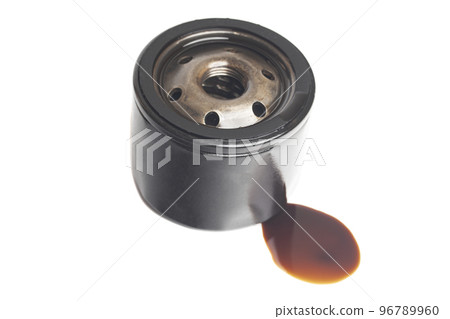 Car oil filter with a puddle of engine oil isolated on white background Car oil filter with a puddle of engine oil isolated on white background 96789960
