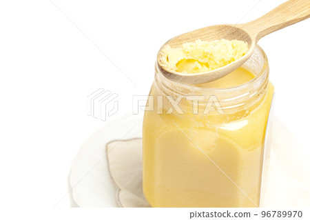 Ghee in jar and wooden spoon isolated on white background 96789970