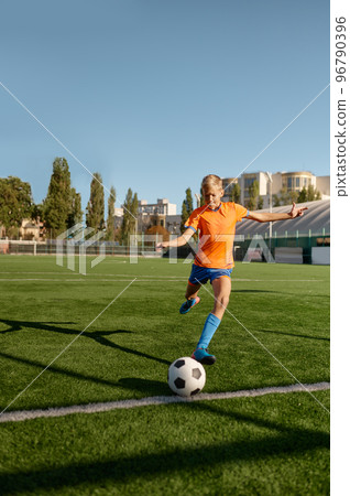 Young soccer goalie starting game kicking ball from white goal line Young soccer goalie starting game kicking ball from white goal line 96790396