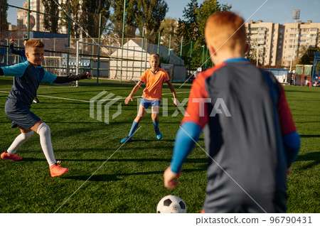Young boys in sports soccer club on training unit improving skills 96790431