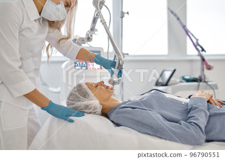 Woman client getting skin treatment at professional beauty clinic 96790551