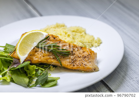 grilled salmon served with couscous and vegetables salad 96790702