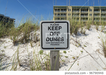 Please Keep Off Dunes, Dune Restoration in Progress signage on white sand with grass at Destin, FL 96790948