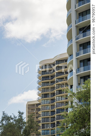 Row of condominiums with different exterior against the pastel sky in Miami, Florida 96790957