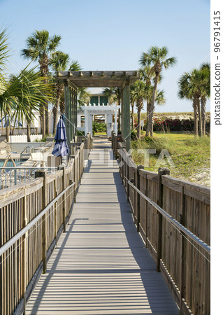 Destin, Florida- Pathway with wooden handrails with pergola roofs Destin, Florida- Pathway with wooden handrails with pergola roofs 96791415