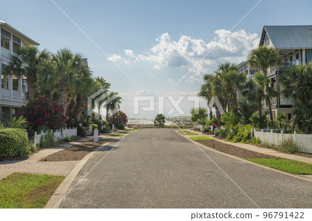Destin, Florida- Street on a suburban area with grass near the sidewalks at the front of the houses 96791422