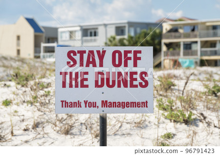 Sign on a post with Stay Off the Dunes Thank You from Management at Destin, Florida 96791423