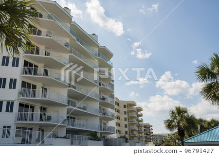 Destin, Florida- Row of apartments with palm trees outdoors 96791427