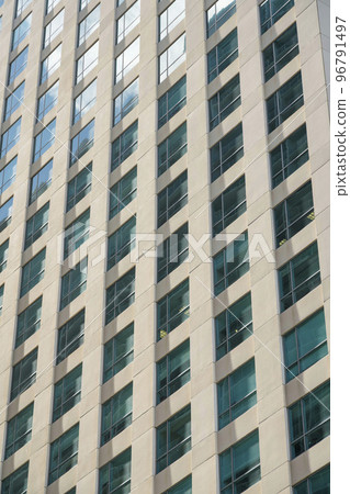Grid multi-storey building close-up with clear reflective glass windows at Miami, Florida 96791497