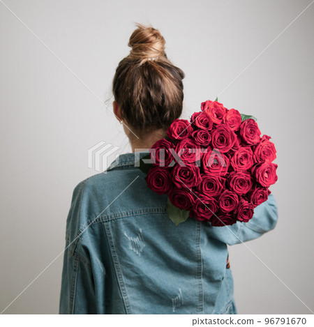 Back view of woman, holding Viva Magenta roses Back view of woman, holding Viva Magenta roses 96791670
