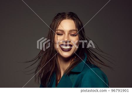 Happiness. Emotional young beautiful girl with artistic makeup laughing over grey background. Concept of beauty, magazine style and human emotions 96791901