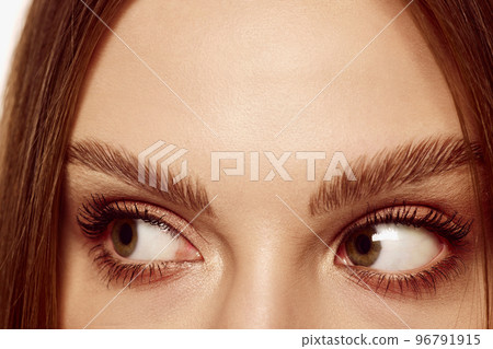 Look away. Close up of beautiful brown female eyes. Perfect trendy eyebrow. Concept of vision, contact lenses, trendy eyebrow makeup concept. 96791915