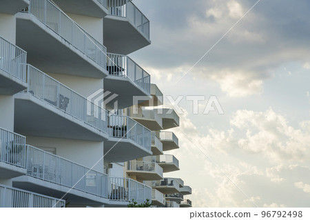 Row of apartments with coffee tables and chairs on each balconies in Destin, Florida 96792498