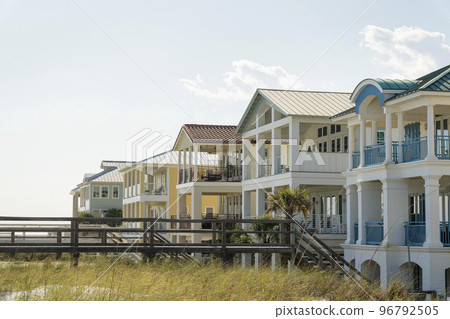 Destin, Florida- Footbridge with stairs on a white sand dunes of a beach at the front of houses Destin, Florida- Footbridge with stairs on a white sand dunes of a beach at the front of houses 96792505