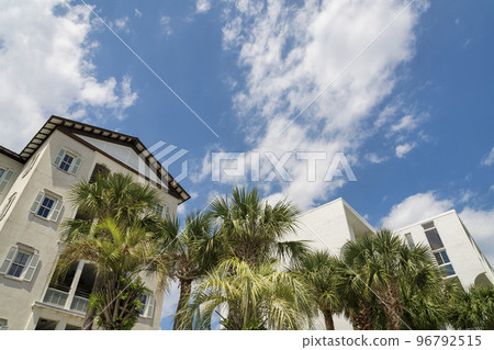 Destin, Florida- Low angle view of a multi-storey houses with palm trees at the front 96792515