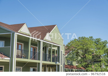 Destin, Florida- Adjacent two-storey office buildings with balconies and painted wood siding 96792516