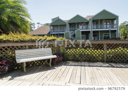 Business plaza with white bench and wood deck near the beach in Destin Florida 96792579